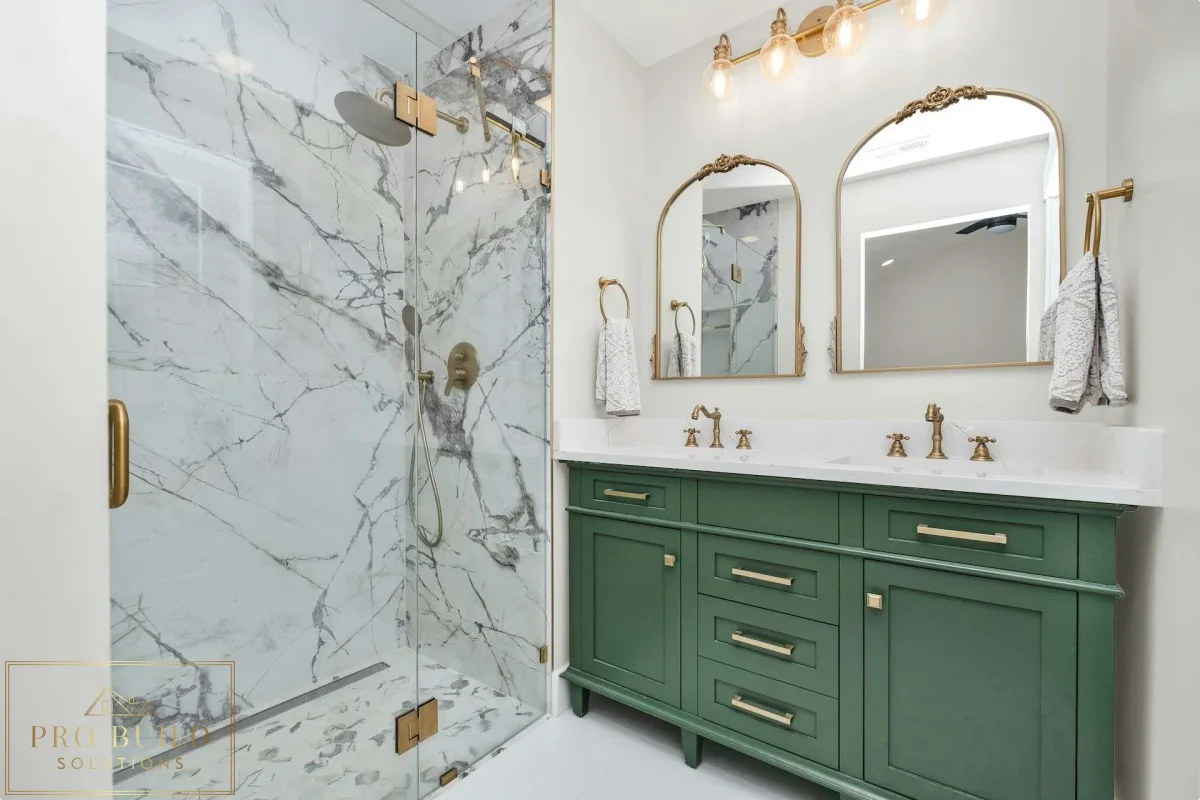 Elegant traditional bathroom design featuring a custom green vanity, frameless marble shower, and warm brass hardware, Elmhurst, IL