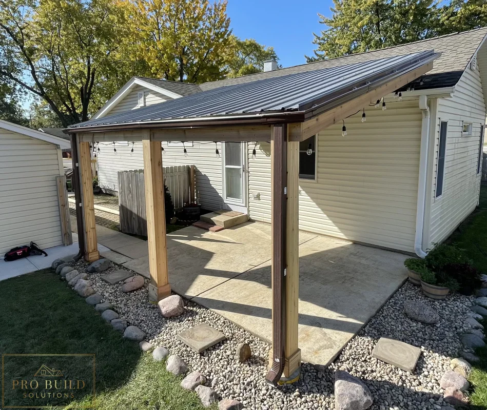 Wood-framed patio roof extension creating a shaded outdoor seating area in a residential yard, Rolling Meadows, IL