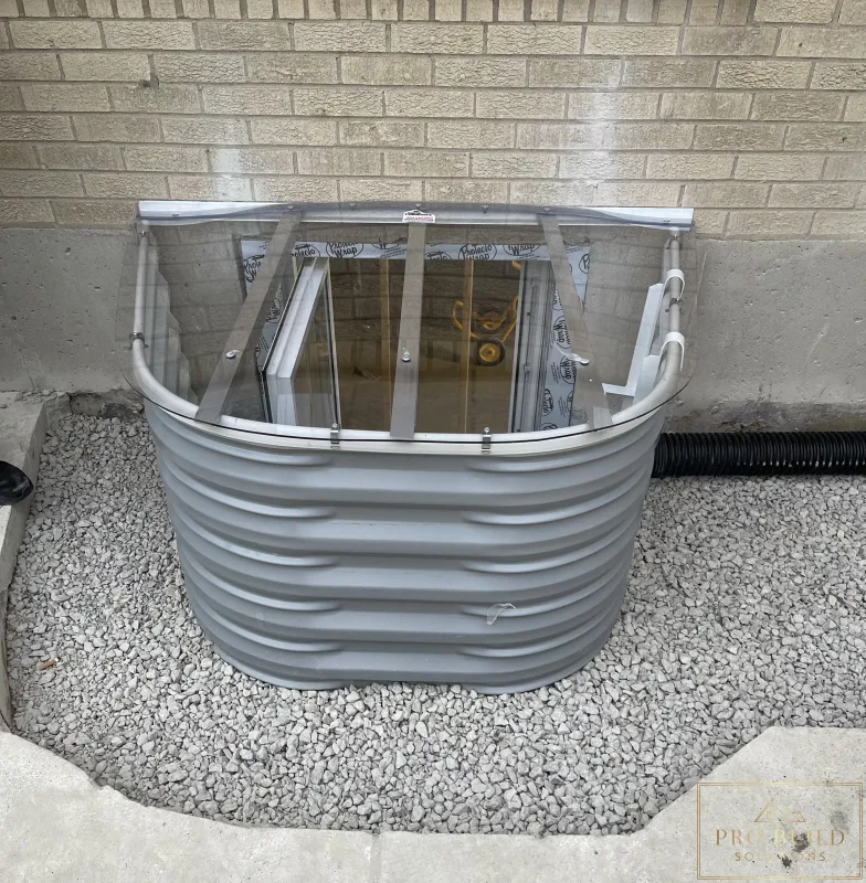 Completed Egress 24"w * 48"h with Window Well Cover backfilled with gravel before Concrete finish, Elmhurst