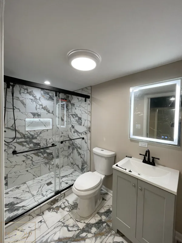 Small bathroom remodel with walk-in shower, marble-look tile, updated vanity, and neutral wall finishes, Itasca
