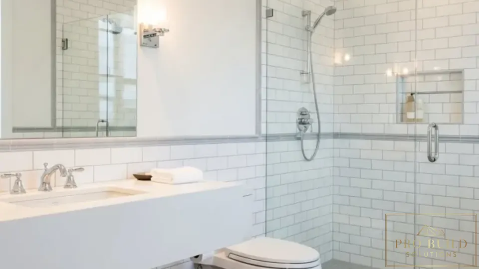 Clean traditional bathroom design featuring a glass walk-in shower, white tile walls, and timeless neutral finishes, Addison